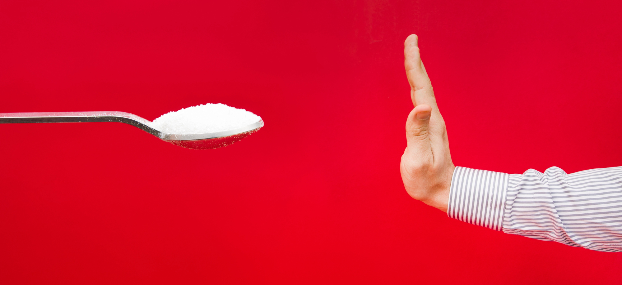 hand saying no to spoonful of sugar