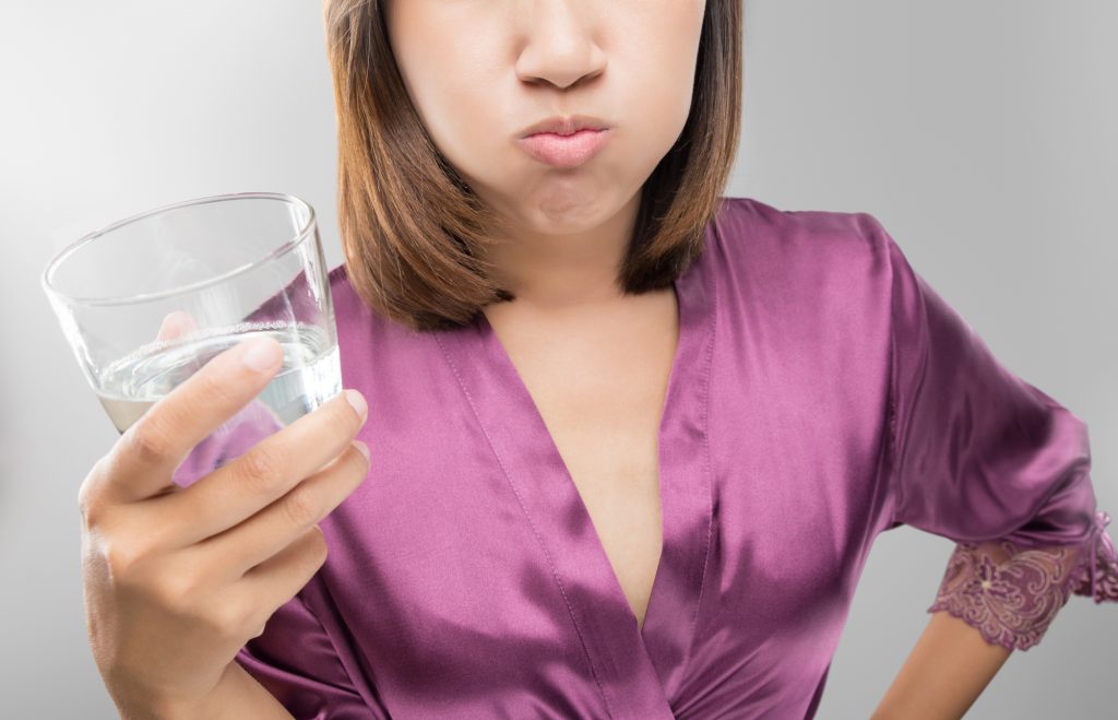 woman rinsing with mouthwash