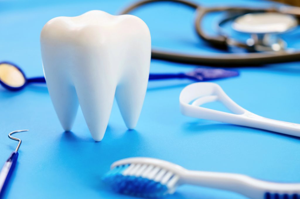 model tooth with dental and medical tools